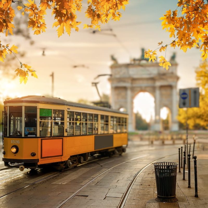 View of the Peace Arch with yellow tram in Milan, Italy